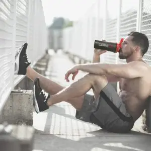 man sitting using corefx shaker cup