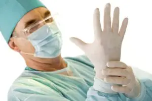 medical staff putting on gloves