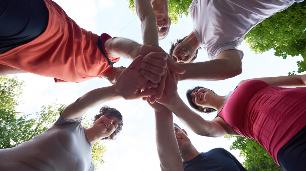 athletes putting hands together